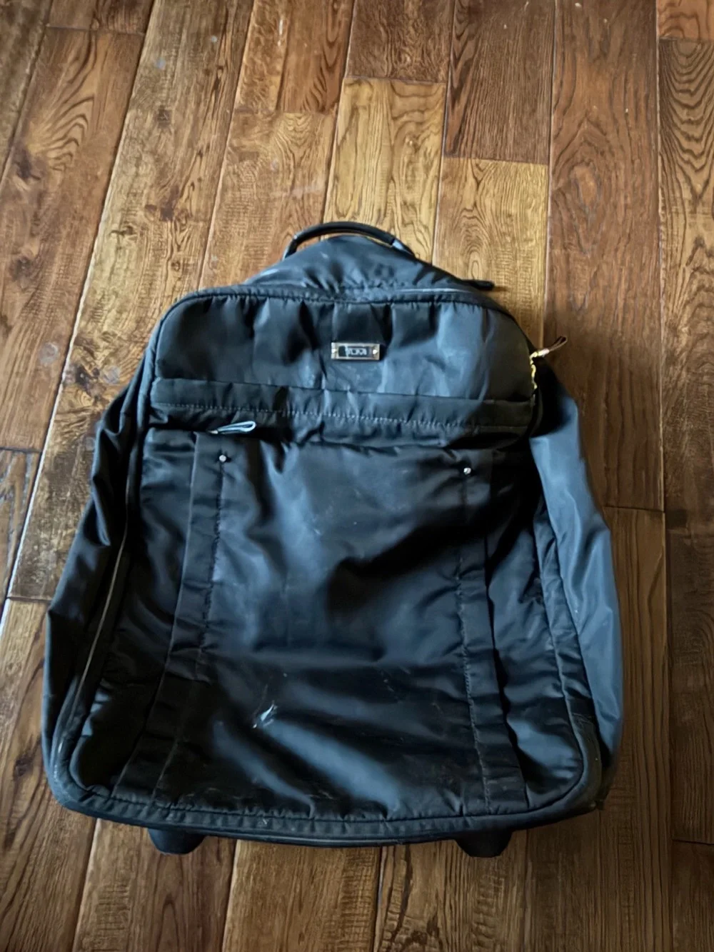 Tumi Black Travel Backpack with Gold Zipper Accents